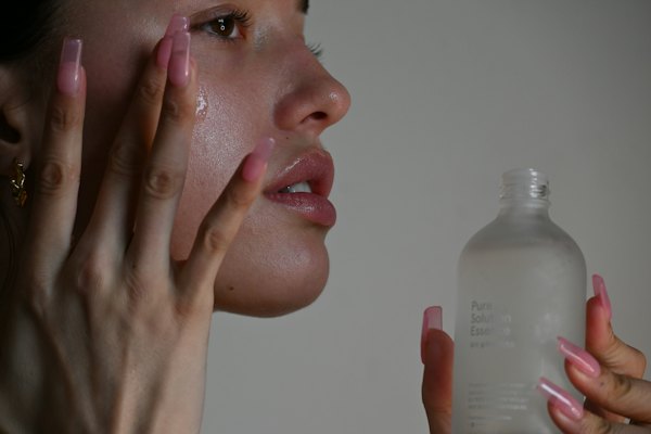 Someone pressing serum into their cheek