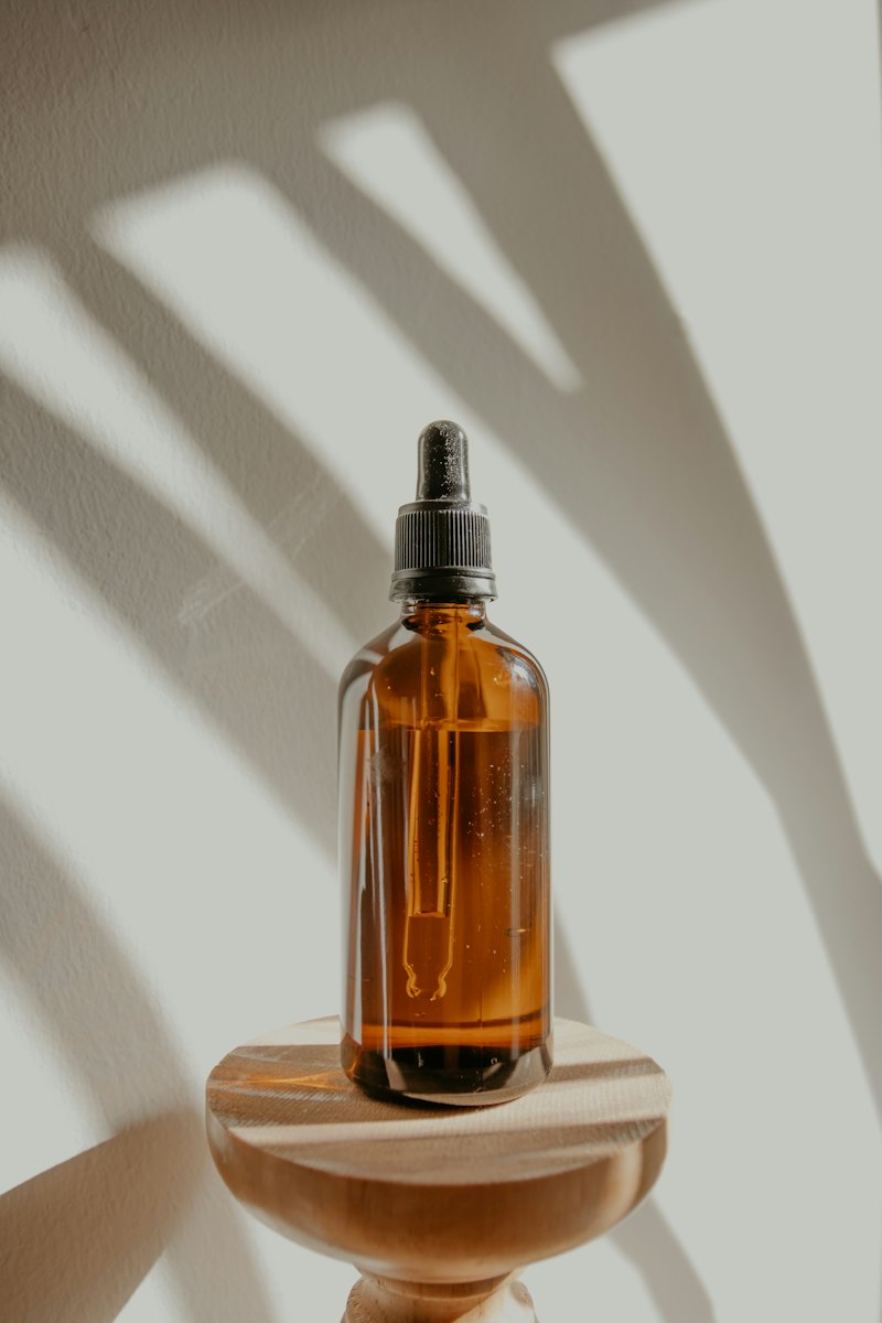 An amber dropper bottle in afternoon light